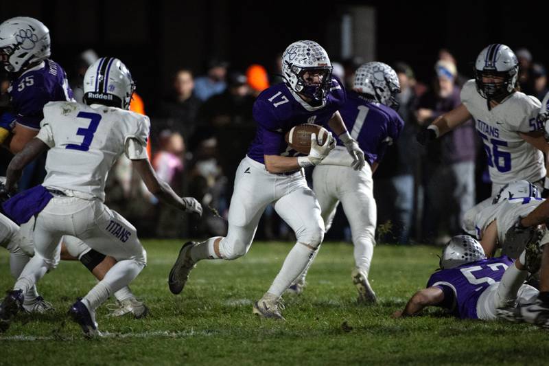 Wilmington's Nate Cupples, center, carries the ball on a play in the Class 2A semifinal against El Paso-Gridley on Saturday, November 22, 2025.