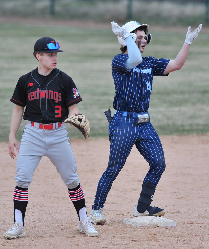 Nazareth's Lucas Smith tries to rally his teammates after hitting a double in the bottom of the seventh inning as Benet Academy shortstop Cole Rosenthal (3) watches for the ball during a game on Apr. 12, 2022 at Nazareth Academy in LaGrange Park.