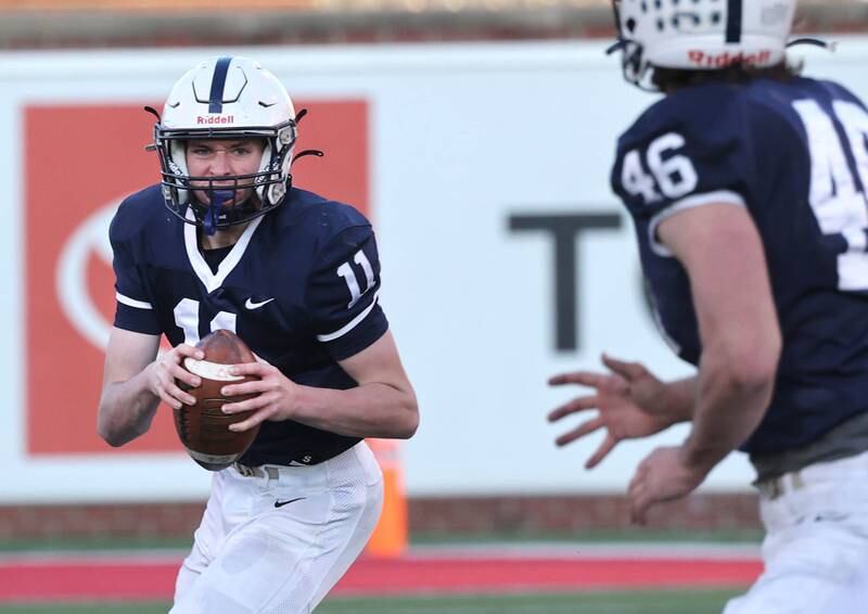 Cary-Grove's Peyton Seaburg looks to throw the ball to Cary-Grove's Logan Abrams Saturday, Nov. 25, 2023, during their IHSA Class 6A state championship game against East St. Louis in Hancock Stadium at Illinois State University in Normal.