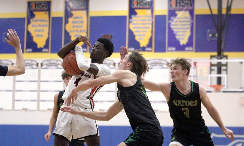 Huntley’s Jeffrey Cruickshank gathers a rebound against Crystal Lake South in varsity basketball tournament title game action at Johnsburg Friday.