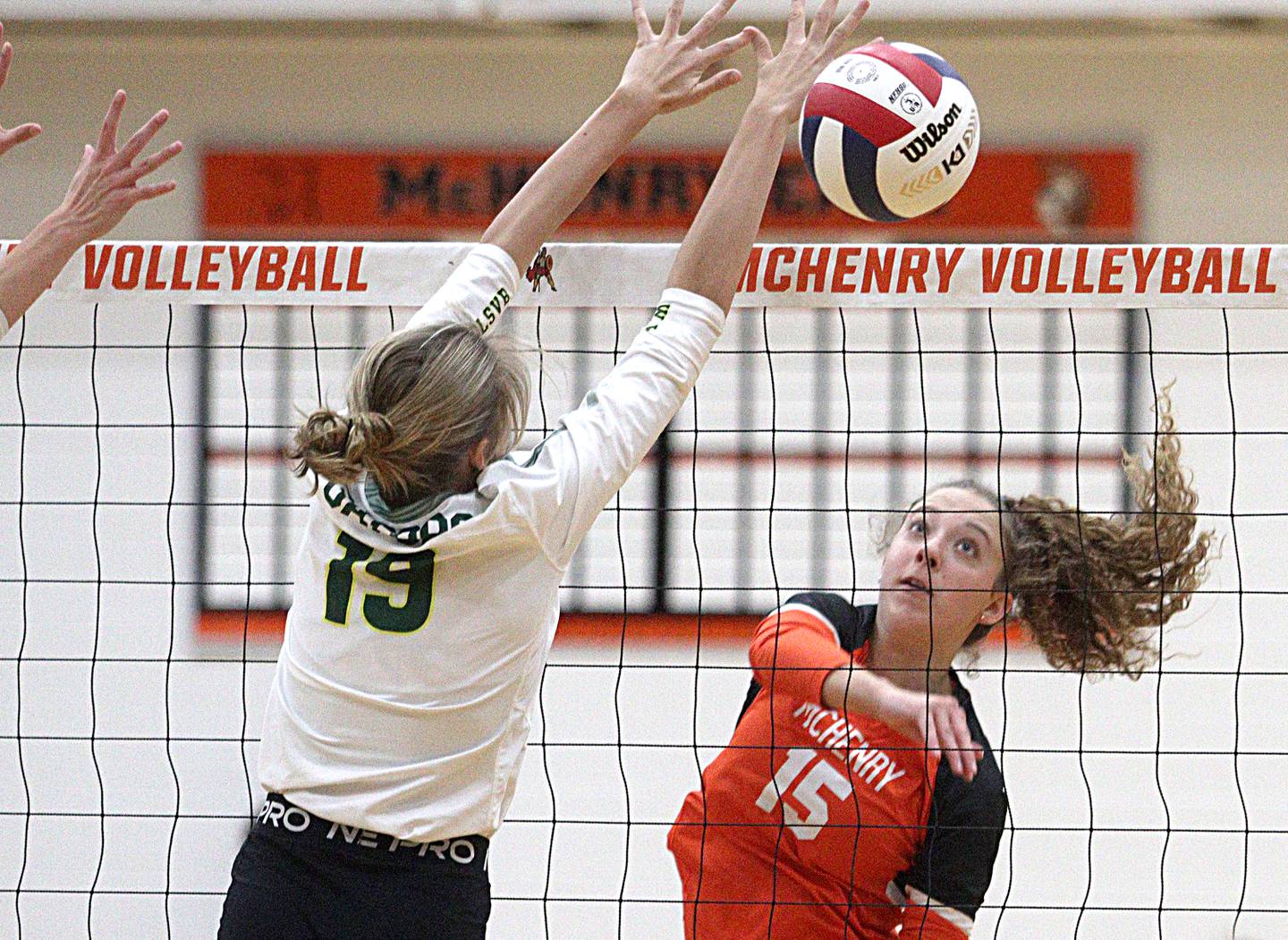 Crystal Lake South’s Logan Georgy, left, and McHenry’s Sophie Zieba battle at the net in varsity volleyball at McHenry Tuesday night.