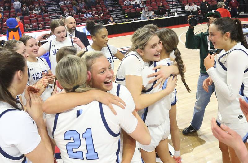 Members of the Nazareth girls basketball team hug and react after winning the Class 4A State championship over Loyola on Saturday, March 7, 2026 at CEFCU Arena in Normal.