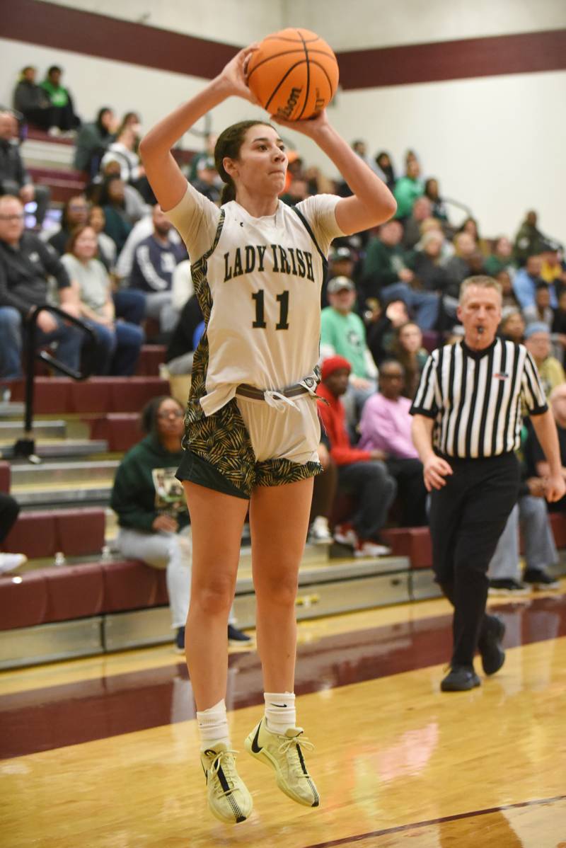 Bishop McNamara's Trinity Davis shoots a 3-pointer during McNamara's IHSA Class 2A Tolono Unity Super-Sectional against Mt. Carmel Monday, March 3, 2025.