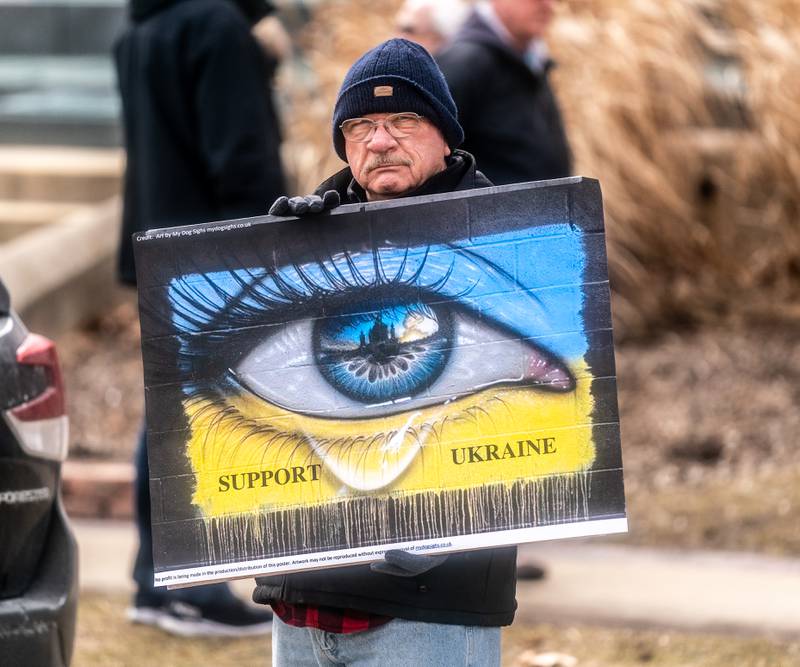 Borys Jurkiw of Geneva holds a poster to protest the war in Ukraine in front of the old Kane County courthouse on Third St in Geneva on Sunday, March 6, 2022.