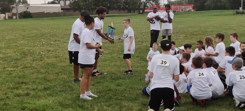 NIU defensive back and DeKalb grad Jordan Gandy hands out a trophy on Sunday, July 24, 2022 at the Youth Pride Foundation Skills and Drills Football camp.