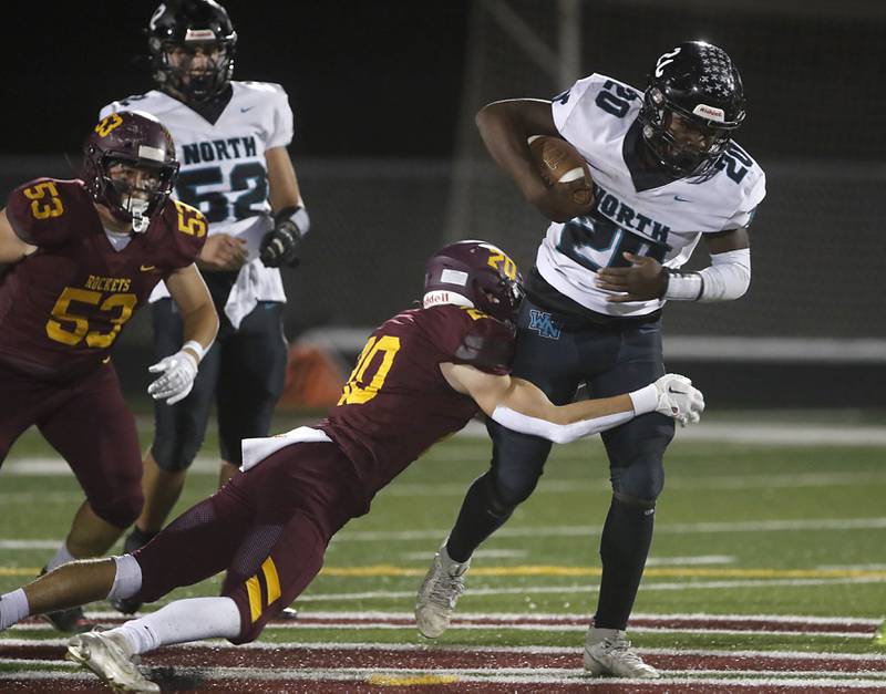 Richmond-Burton's Luke Johnson tries to tackle Woodstock North's David Randecker during a Kishwaukee River Conference football game on Friday, Oct. 11, 2024, at Richmond-Burton High School.