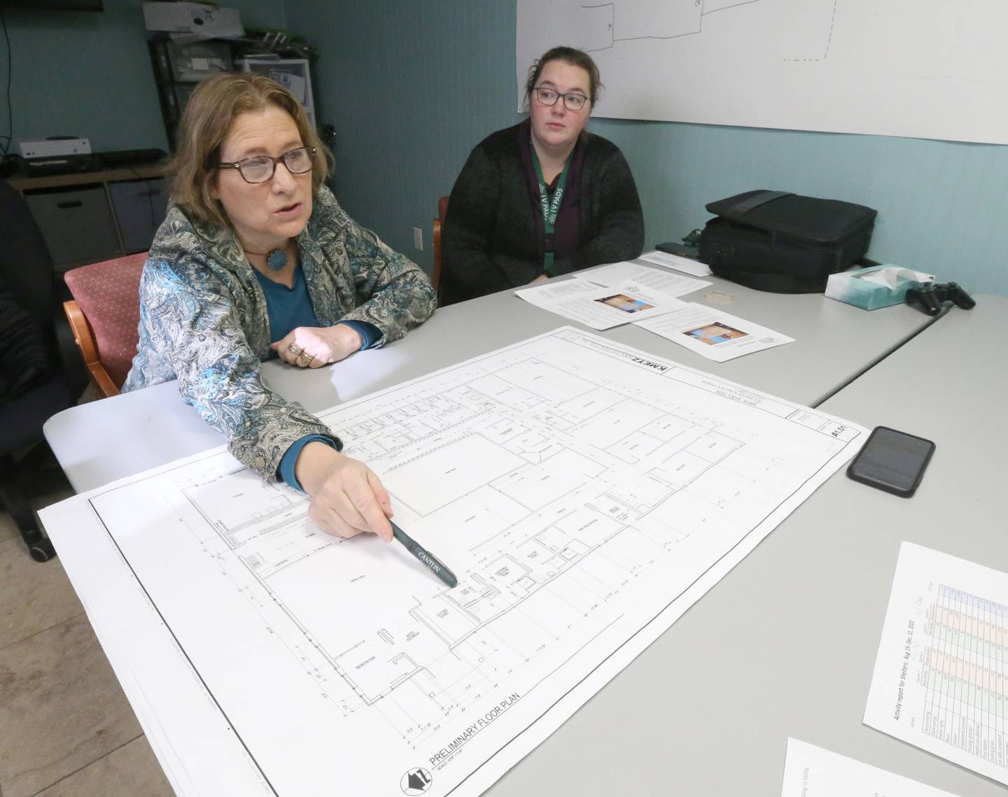 Carol Alcorn executive director of the Illinois Valley Public Action To Deliver Shelter (PADS) on unveils a new blueprint of initial plans to develop a 11,238 square foot building on the existing property which includes the current building to be demolished on Wednesday, Feb. 1, 2023 in Ottawa. The approximate cost of the new building project will be 3.5 million. The current Ottawa shelter is housed in a 165 year-year-old building with problems that include inadequate space and extensive temperature control issues. The space of the facility tightly houses 55 individuals and is currently full. Funding for the project will begin soon. Alcorn hopes that construction will begin within the next few years or sooner.