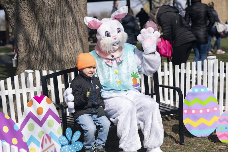 Luke Overton, 5, of Capron, visits with the Easter Bunny during an Easter Egg Hunt on Saturday, April 16, 2022 at Deicke Park in Huntley. The Huntley Park District put out 11,000 plastic eggs.