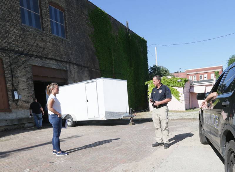 Leah Inman La Salle Economic Development director and La Salle Police Chief Mike Smudzinsi gather before going into the Hotel Kaskaskia on a search warrant on Thursday, June 16, 2022 downtown La Salle.