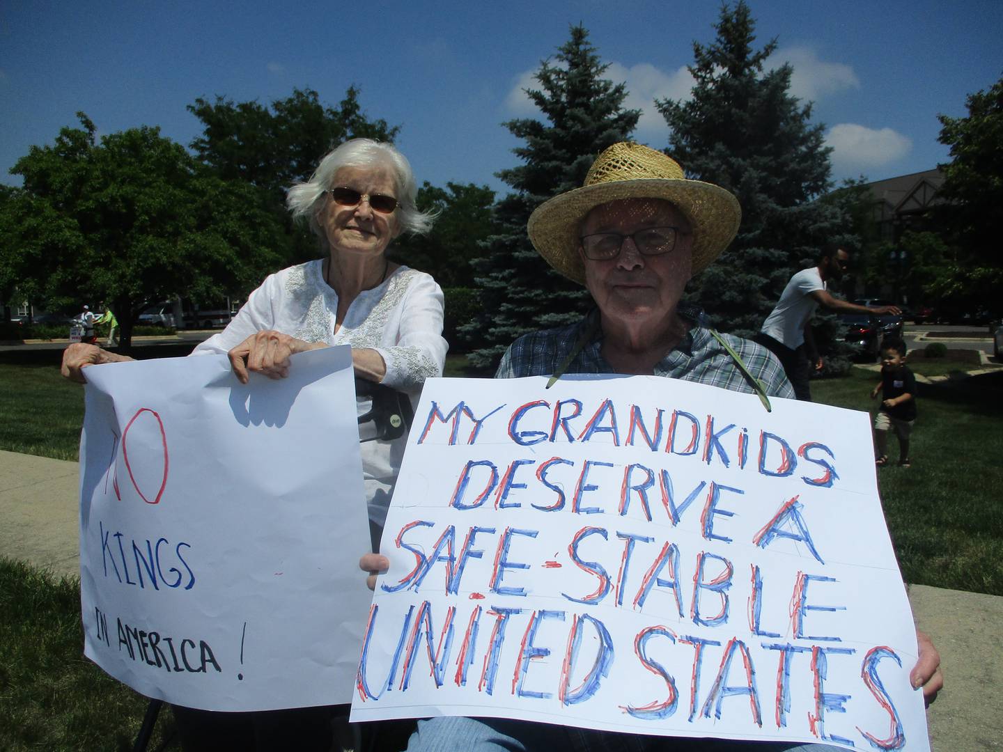 Mike Hall, a former high-school social studies teacher, and friend Clara Sweet, show their opposition to actions by the Trump administration at a demonstration outside the Timbers of Shorewood senior living center on Saturday. June 14, 2025