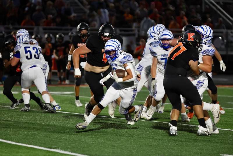 Princeton's Ace Christiansen busts through a hole on a run in Friday's game at Kewanee. The Tigers won 44-15.