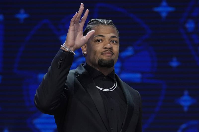 Washington wide receiver Rome Odunze walks on stage during the first round of the NFL football draft, Thursday, April 25, 2024, in Detroit. (AP Photo/Jeff Roberson)