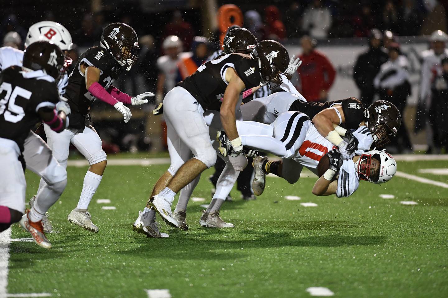 Joliet Catholic Academy's Max Hrvatin Brings down Benet Academy's Charley Cooney during a game  Friday Oct. 14, 2022 at Joliet Memorial Stadium