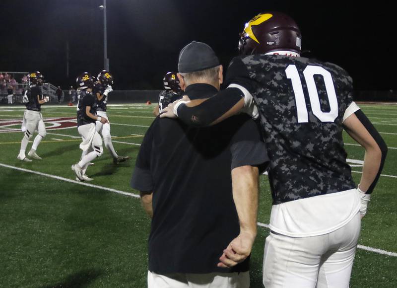 Richmond-Burton's Luke Robinson hugs Richmond-Burton Head Coach Mike Noll after Noll won his 300 career football game a on Friday, Oct. 17, 2025, at Richmond-Burton High School in Richmond.