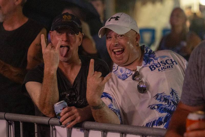 Fans make the "Rock and Roll" hand signal during the Thunderstruck performance at the annual Cops for Cancer event on Friday, July 25, 2025, at Cerri Memorial Park in Cedar Point.