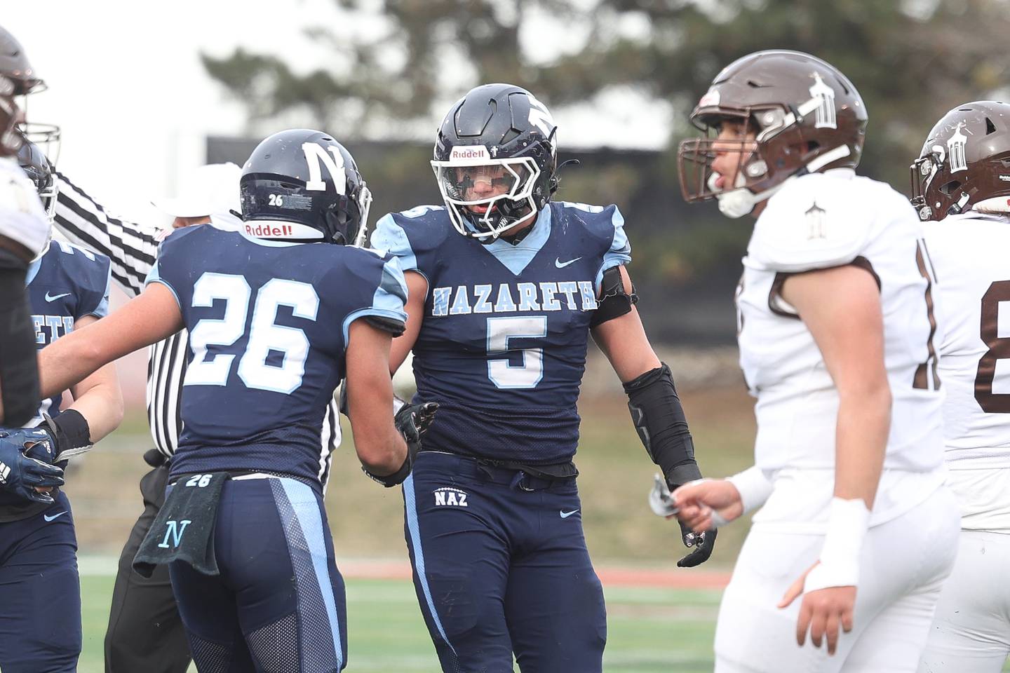Nazareth’s Gabe Kaminski (5) congratulates a teammate on a defensive stop against Joliet Catholic in the Class 5A state championship on Saturday, Nov. 30, 2024 in Normal.