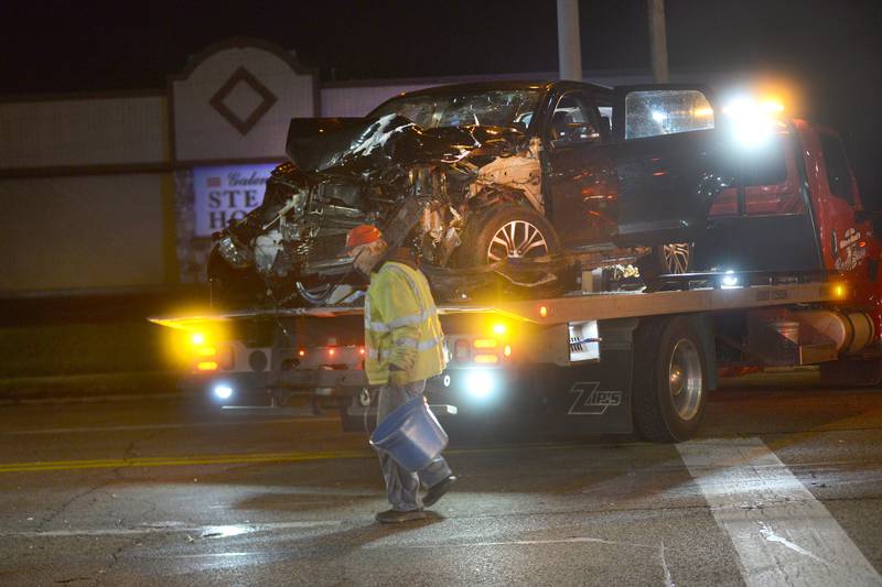 Emergency personnel pick up debris following a three-vehicle crash at the intersection of North Galena Avenue and Court Street in Dixon about 5 p.m. Tuesday, Dec. 5, 2023.