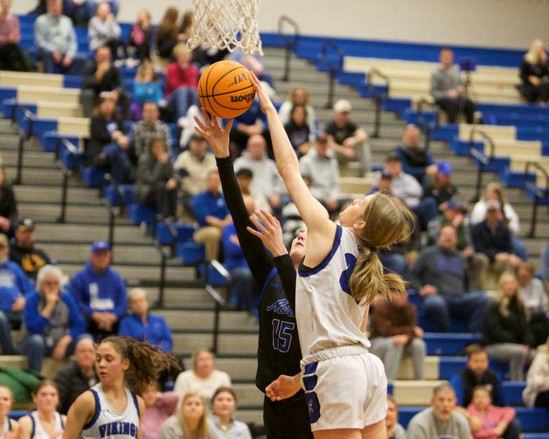 St. Charles North's Bronwyn How goes in for the layup as Geneva's Bridget Hecker goes for the block on Friday, Jan. 17,2025 in Geneva.