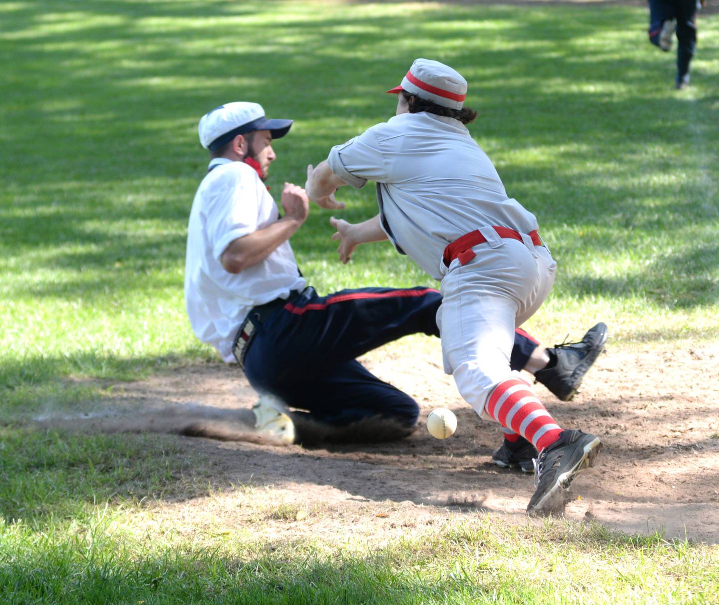 Oregon Ganymedes catcher Tom "The Dandy" Lesniak tries to tag out a runner in the opening game at the 21st Annual World Tournament of Historic Base Ball in Dearborn, Michigan on Saturday, Aug. 10, 2024.