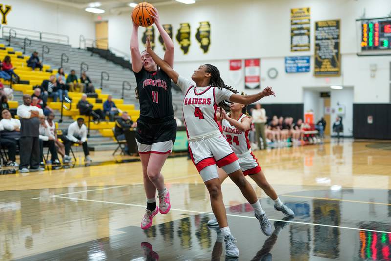 Bolingbrook's Sydney Dodd (4) defends the paint against a shot attempt by Yorkville's Brooke Spychalski (11) during a Class 4A Metea Valley Regional final basketball game at Metea Valley High School in Aurora on Friday, Feb. 21, 2025.