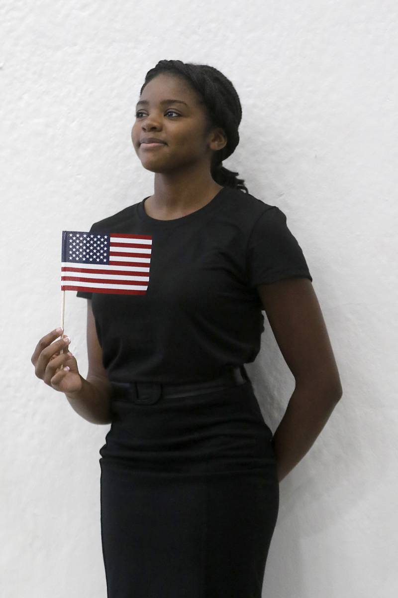 McHenry High School senior Molara Fashola who sang “MLK” with other members of the choir during a celebration for veterans returning from the McHenry County Honor Flight trip to Washington D.C, are celebrated on Sunday, Aug. 27, 2023, holds an American Flag as she watches the celebration. The simplicity of this image is what I love the pride on Molara’s face as he holds the flag.