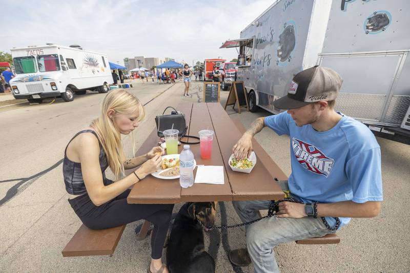 Violet Lilly and Tyler Garmin of Rock Falls dig into some tacos Saturday, Sept. 13, 2025, at Taste of Fiesta in Rock Falls. Several food trucks and booths filled the air with scents of sizzling meats and spices that added to a great day along the riverfront.