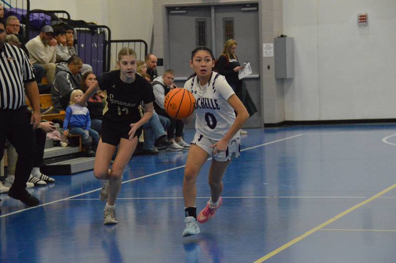 Rochelle's Ariana Hueramo dribbles the ball up the court in a JV basketball game.