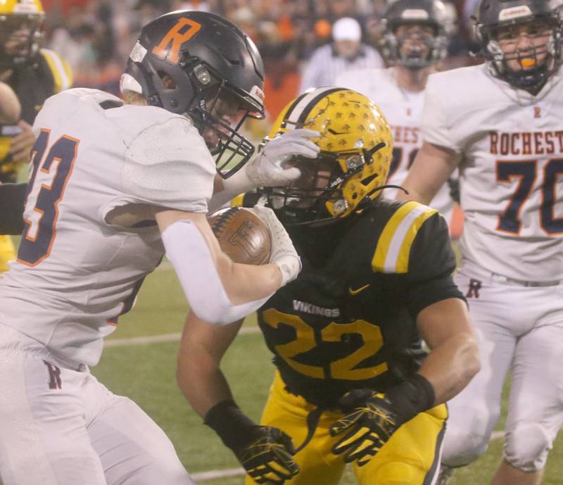 Rochester's Nolan Mrozowski stiff arms St. Laurence's Connor Cleary during the Class 4A State football championship on Friday, Nov, 24, 2023 at Hancock Stadium in Normal.