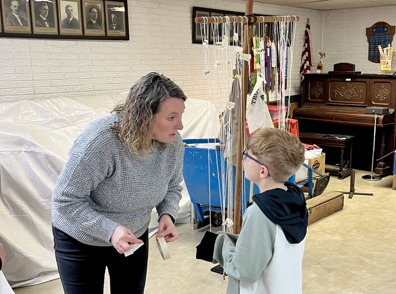 Assistant Cub Master Carrie Smith talks to a scout during Monday's meeting of Cub Scouts Pack 4151 in Princeton. It was the first meeting for the pack, which was restarted after a mutli-year hiatus.