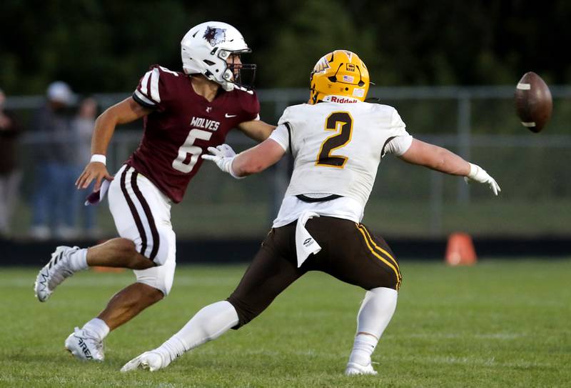 Prairie Ridge's Luke Vanderwiel tosses the football as he is pressured bu Jacobs' Caden DuMelle during a Fox Valley Conference football game on Friday, Sept. 5, 2025, at Prairie Ridge High School in Crystal Lake.