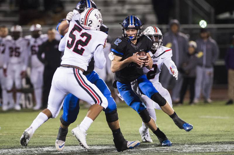 Lincoln-Way East's Jack Baltz tires to escape Bolingbrook's defense on Friday at Lincoln-Way East in Frankfort.