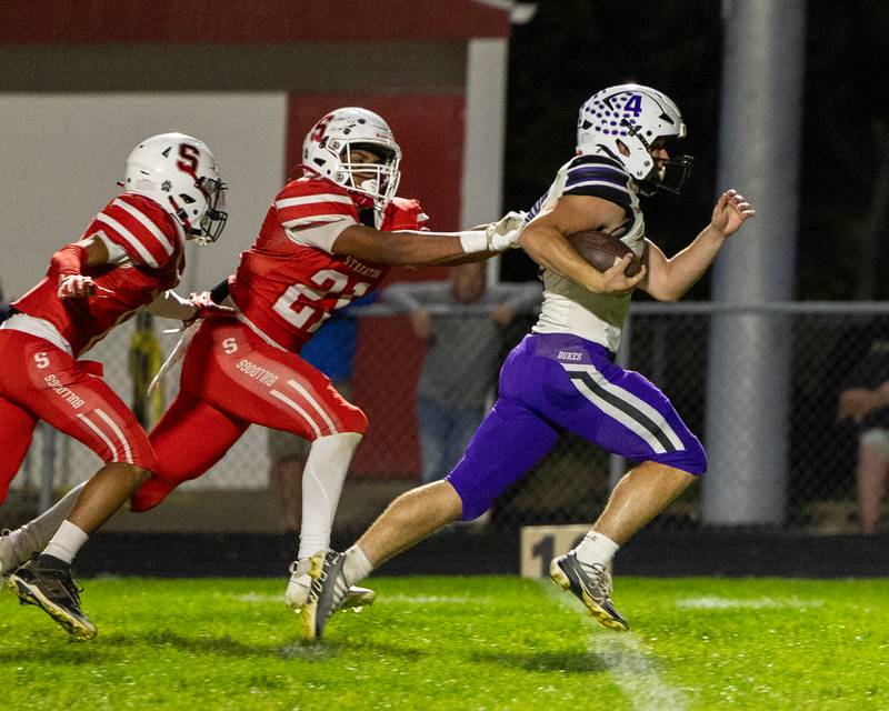 Landon Knigge (4) of Dixon runs ball for touchdown as Lavontae Horton (21) of Streator latches onto his jersey on Friday, October 17, 2025 at Streator High School in Streator.