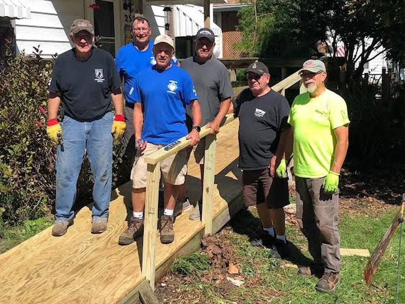 Sterling Knights of Columbus members Mark Terveer, John Clark, John Gehrke, Gary Velasquez, Mike Terveer, and Bob Marruffo build a deck for a Knights member who recently suffered a stroke and lost the use of his legs.