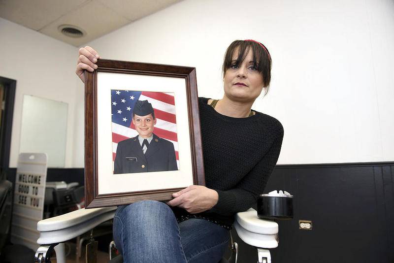 Patriot Barbershop owner Erin Dietrich wants her shop to be more than just a place to get a trim. It will be a place where her fellow veterans can talk about their experiences in the service if they want. “The barber shop isn’t about me,” she said. “It’s to honor others and love on people, especially veterans, so they’re not forgotten.” Here, Erin, who joined the Army right out of high school, displays a photo of her as a fresh new recruit in 1999.