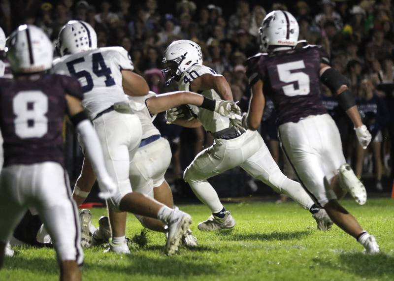 Cary-Grove's Logan Abrams runs for a two-point conversion during a Fox Valley Conference football game against Cary-Grove on Friday, Sept. 27, 2024, at Prairie Ridge High School.