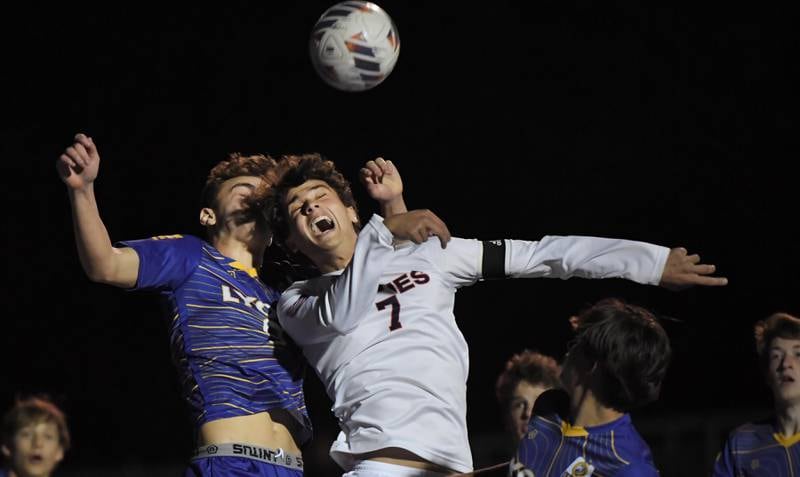 Naperville North’s Noah Radeke and Lyons Township’s Owen Suda compete for a header in front of the Lyons net in the Class 3A state soccer semifinal game in Hoffman Estates on Friday, November 3, 2023.