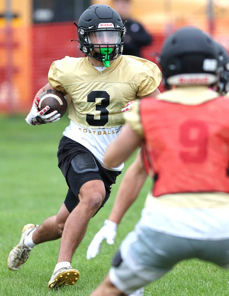 Sycamore's Kayden Galto carries the ball during a kick return drill Monday, Aug. 8, 2022, at the school during their first practice ahead of the upcoming season.