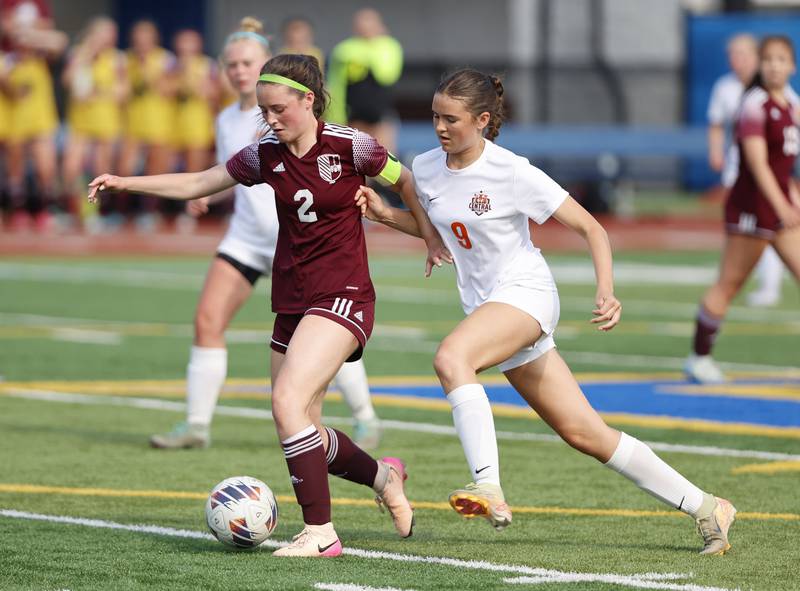 Crystal Lake Central's Avery Watson (9) goes for the ball against St. Ignatius' Quinn Urquhart (2) during the 2A girl's varsity supersectional soccer match between Crystal Lake South and St. Ignatius high schools on Tuesday, June 3, 2025 in Chicago.