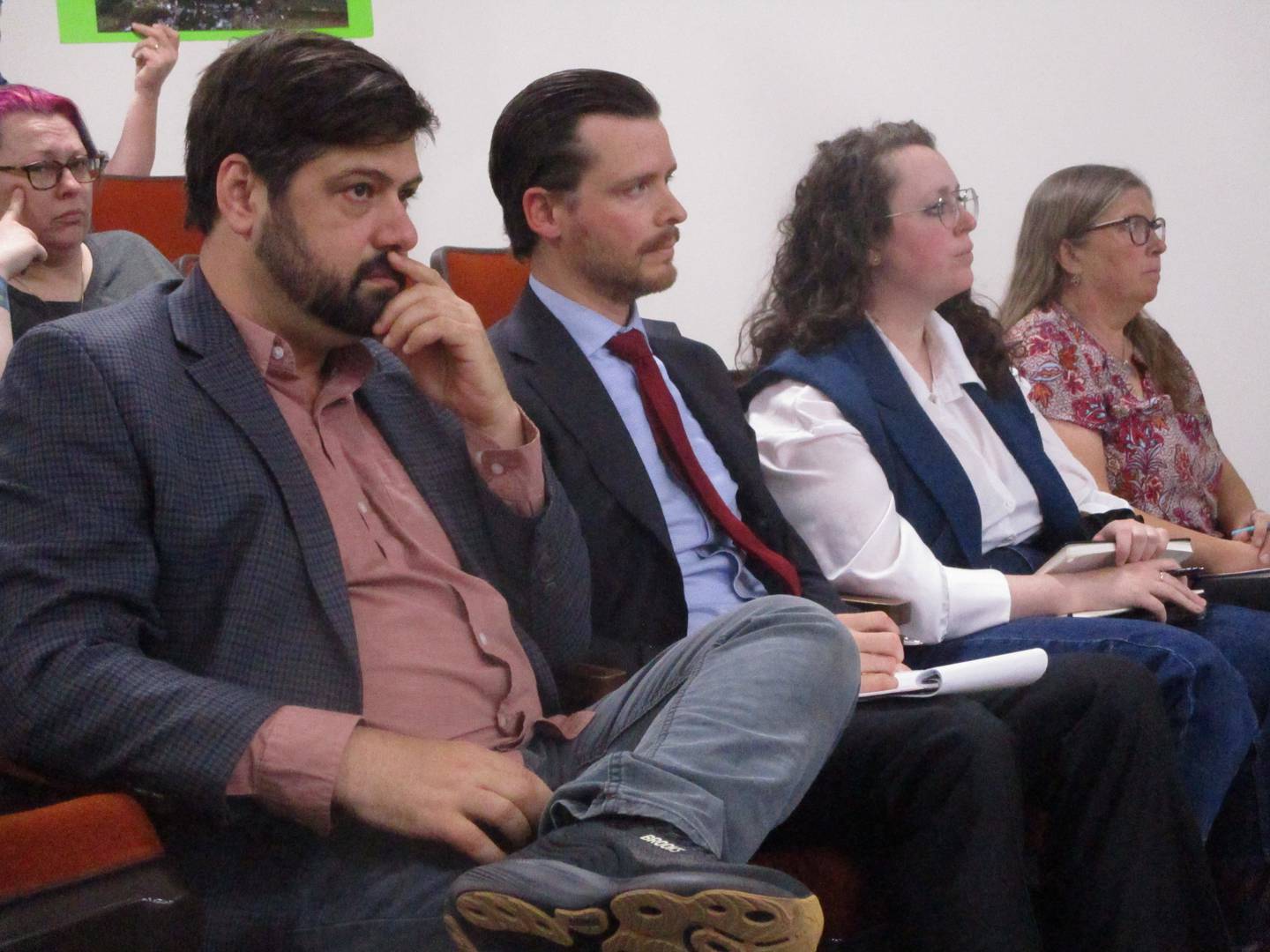 Rob Kalbouss, director of development for Earthrise Energy's plan in Will County, (left) and other representatives from the company listen to discussion about their project at a meeting  of the Will County Board Executive Committee on Thursday. May 14, 2026
