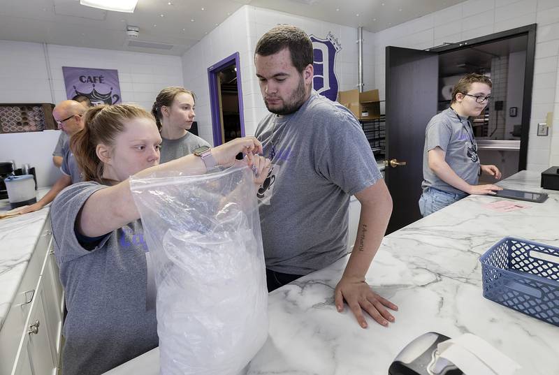 Transition life skills students Traci Miller (left), Jessica Ferris, Anthony Burke and Zachary Fay prepare Cafe Royal Saturday, Oct. 19, 2024, at Dixon High School. The students are operating a new coffee stand in the cafeteria in the morning and afternoon.