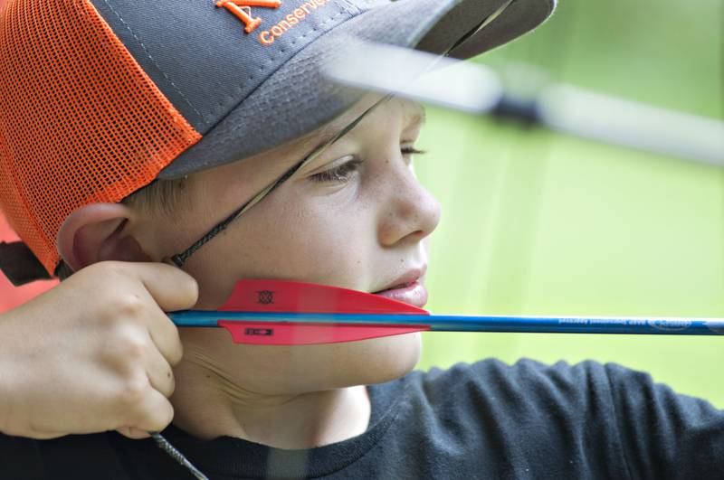Trent Jordan, 9, of Chadwick takes aim Saturday, July 24, 2021 while learning about archery at the Coleta Sportsmans Club’s youth day. The club opened their grounds to allow kids and parents to get  kids interested in fishing, archery and shooting sports and learn about animals and conservation.