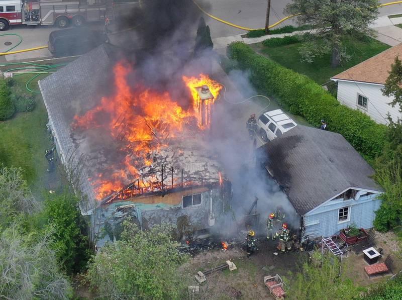 An aerial view of structure fire as flames pour out of the roof in the 1900 block of Main Street on Monday, May 4, 2026 in Peru.