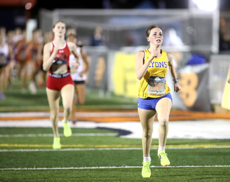 Lyons Township’s Mya Coglianese runs to the finish in the varsity girls race during the Naperville North Twilight Cross Country Invitational on Wednesday, Oct. 9, 2024 in Naperville.