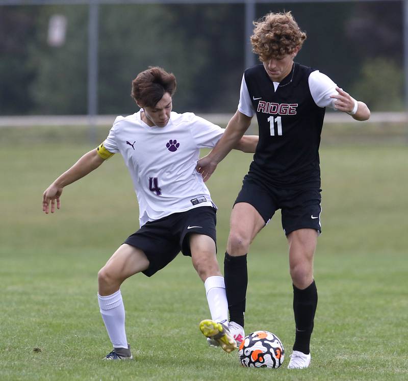 Hampshire's Logan Heileman tries to take the ball from Prairie Ridge's Chase Santucci during a Fox Valley Conference soccer match Tuesday, Sept. 19, 2023, at Prairie Ridge High School in Crystal Lake.