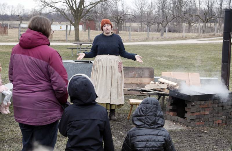 Historical Interpreter Emalee Allison <CQ> explains the finer points of maple sugaring at Kline Creek Farm Saturday March 11, 2023 in West Chicago.