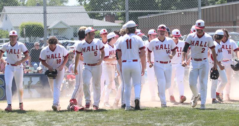 Members of the Hall baseball team walk back to the dugout after teammate Joel Koch hit a home run during the Class 2A Sectional final game on Saturday, May 27, 2023 at Knoxville High School.
