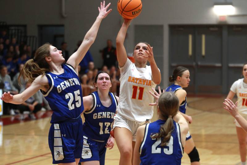 Batavia’s Kaidyn King gets a shot up past Geneva’s Bridget Hecker (left) during a game on Friday, Dec. 20, 2024 in Batavia.