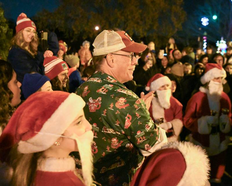 Yorkville’s Mayor John Purcell is all smiles as he listens to what Santa has to say before the tree lighting ceremony on Friday Nov. 21, 2025, held at Riverfront Park in Yorkville.