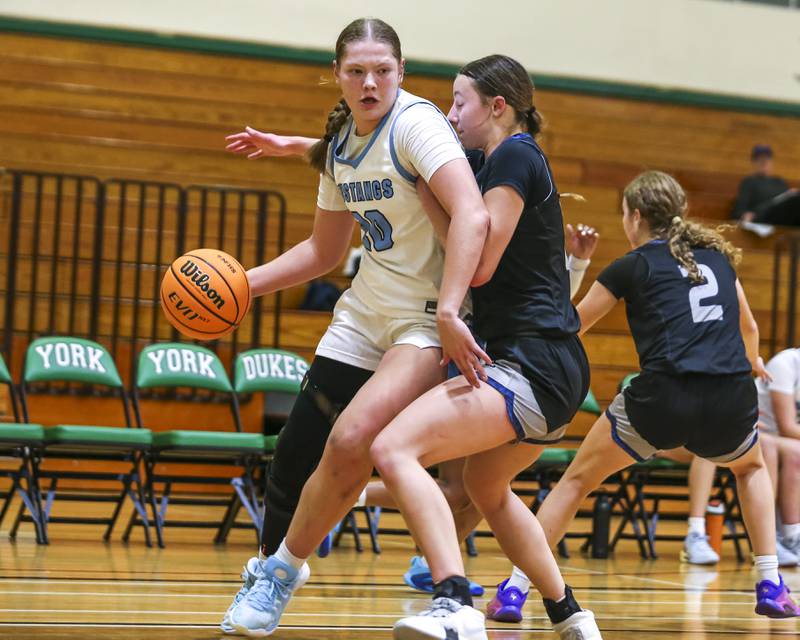 Downers Grove South's Megan Ganschow (20) makes a move around the defense during their York Thanksgiving Tournament matchup between Oswego East at Downers Grove South Friday, Nov 20, 2025 in Elmhurst.
