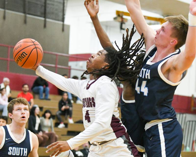 Morton East's Twon Jones (4) goes up for a shot while being dfended by Downers Grove South's Justin Sveiteris (44) in the second quarter on Saturday Dec. 9, 2023, held at Morton East High School.